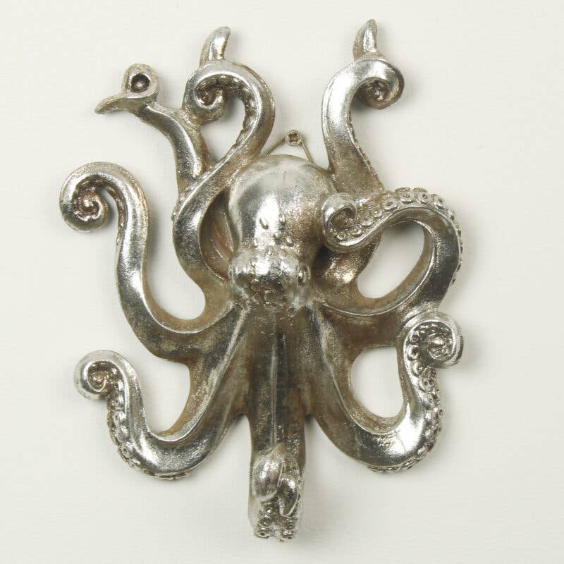 A silver-colored wall hook in the shape of an octopus with curling tentacles.