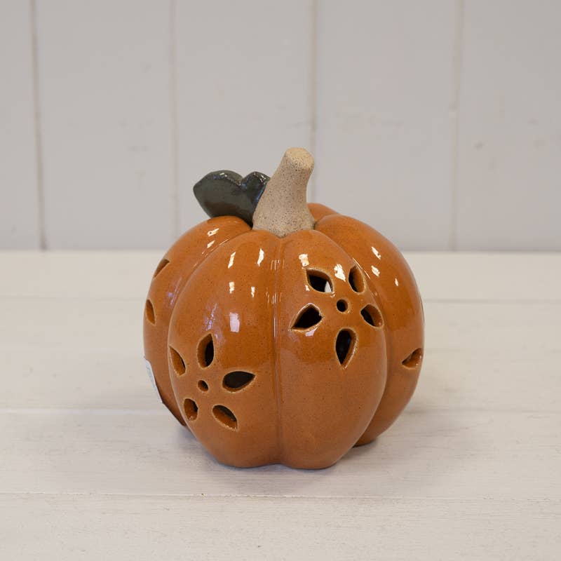 Ceramic pumpkin with cut-out design on a white background