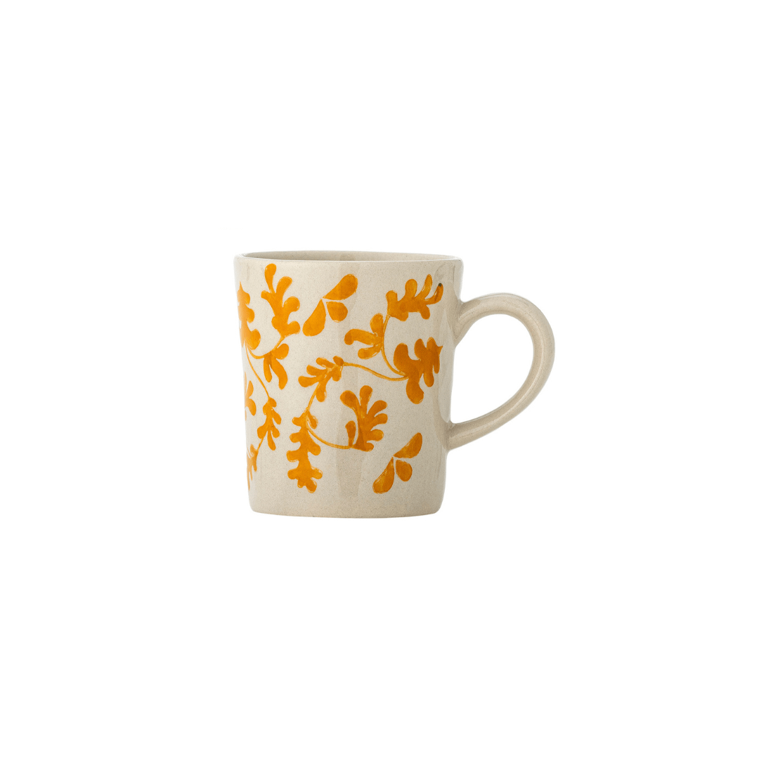 An off-white ceramic mug with a textured finish, decorated with a vibrant orange leafy vine pattern, set against a plain white background.