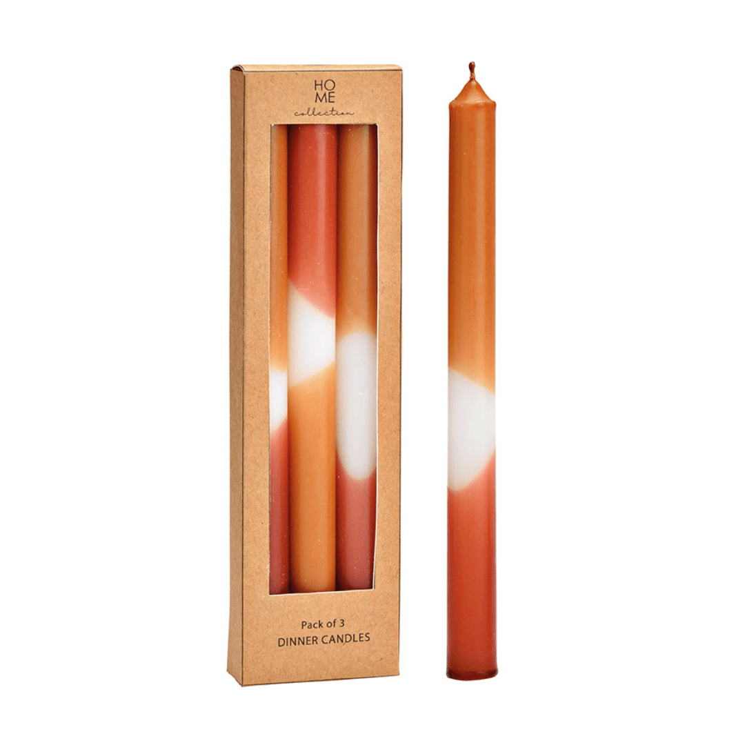 Pack of three dinner candles with a gradient design in a cardboard box labeled 'HOME collection'.