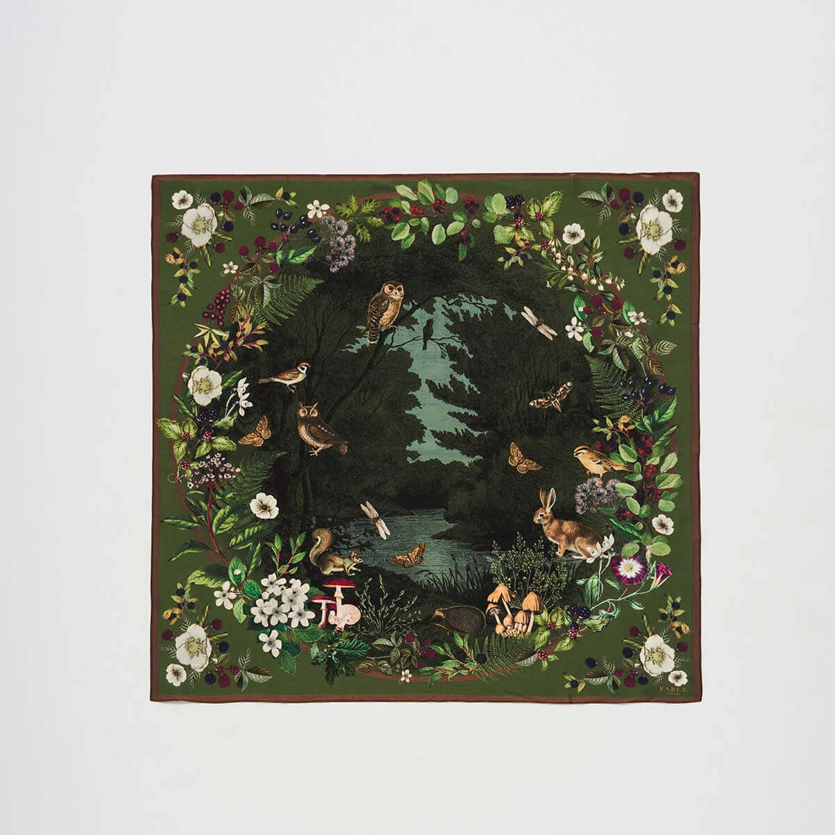 A square silk blend scarf featuring a detailed woodland scene with owls, rabbits, birds, butterflies, and a river, framed by a border of flowers and foliage on a light gray background.