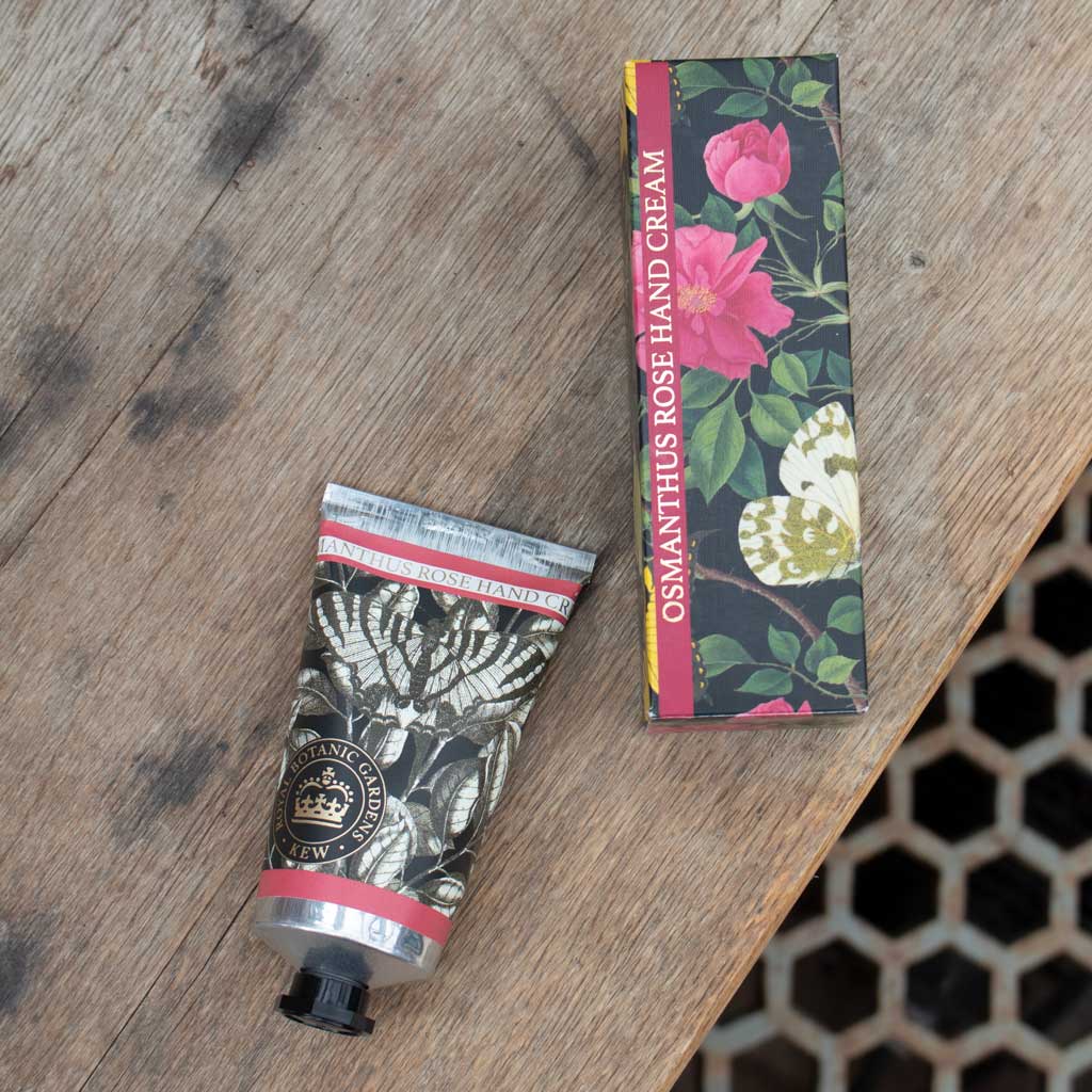 Hand cream tube and packaging on a wooden surface