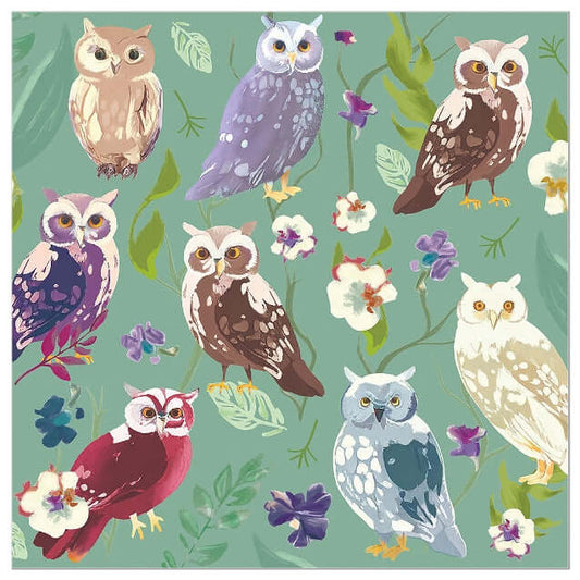 A repeating illustrated pattern of owls in many colors with leaves and small flowers on a muted green background napkin.
