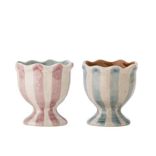 Two striped ceramic egg cups on a white background