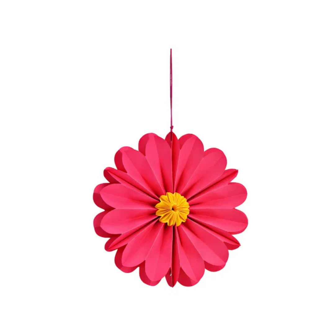 Pink paper flower decoration with a yellow center on a white background
