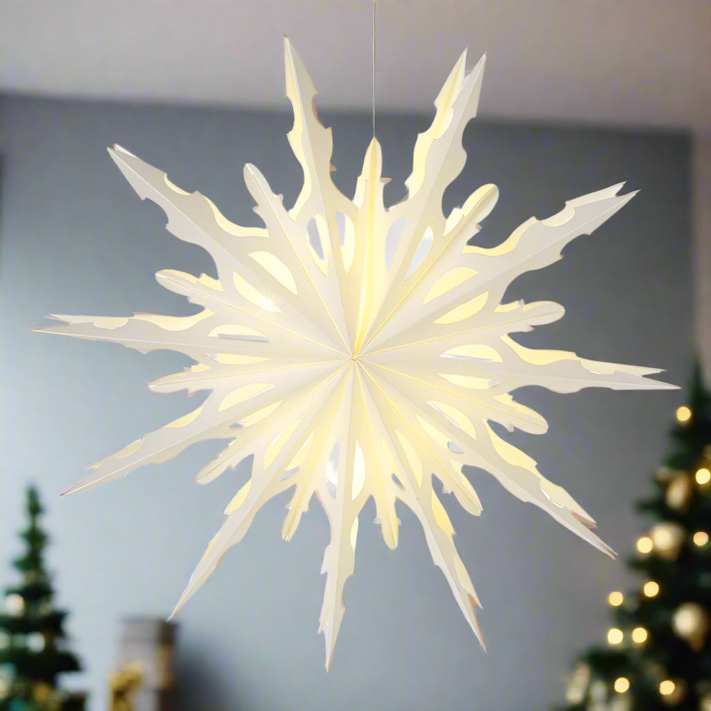 Decorative star-shaped light hanging in a christmas decorated room