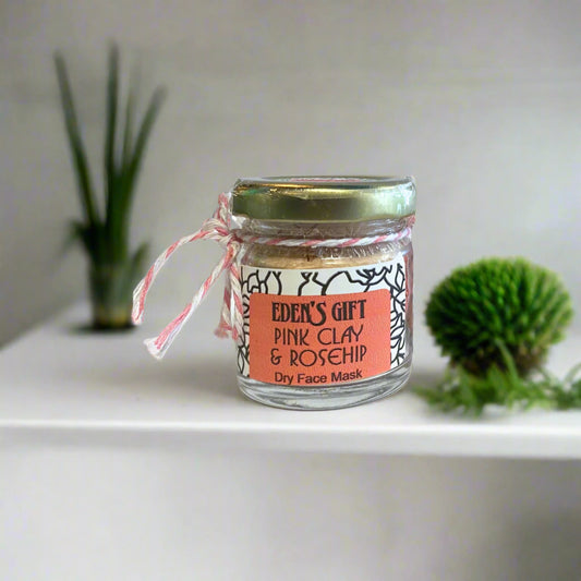 A glass jar with a label that reads 'Eden's Gift Pink Clay & Rosehip Dry Face Mask', tied with a pink ribbon.