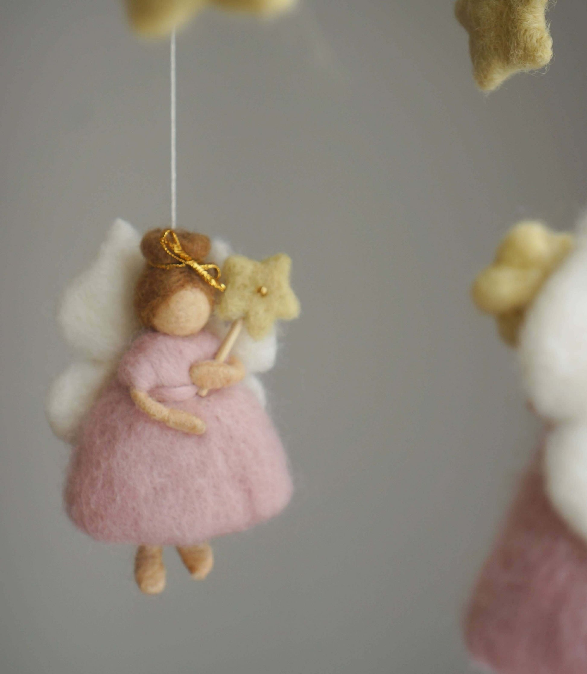 Close up of Pink fairy felt mobile. With wings hair bow and wand