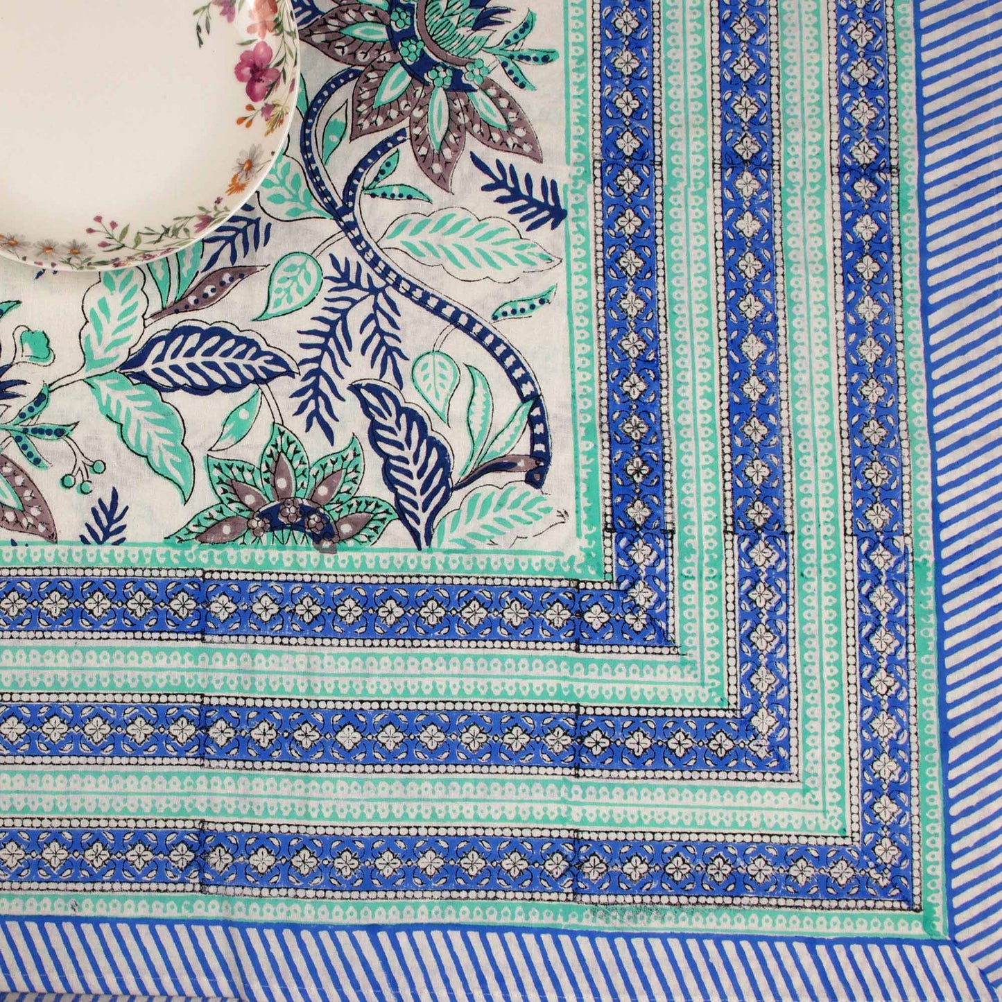Close-up of a decorative fabric with intricate patterns and colors.