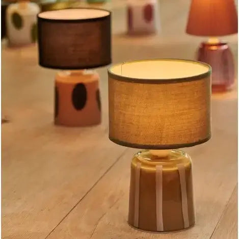 Table lamps with striped bases on a wooden floor