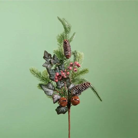 A decorative artificial evergreen branch with pinecones, small pink berries, and dark ivy leaves on a single stem, centered against a solid sage green background.