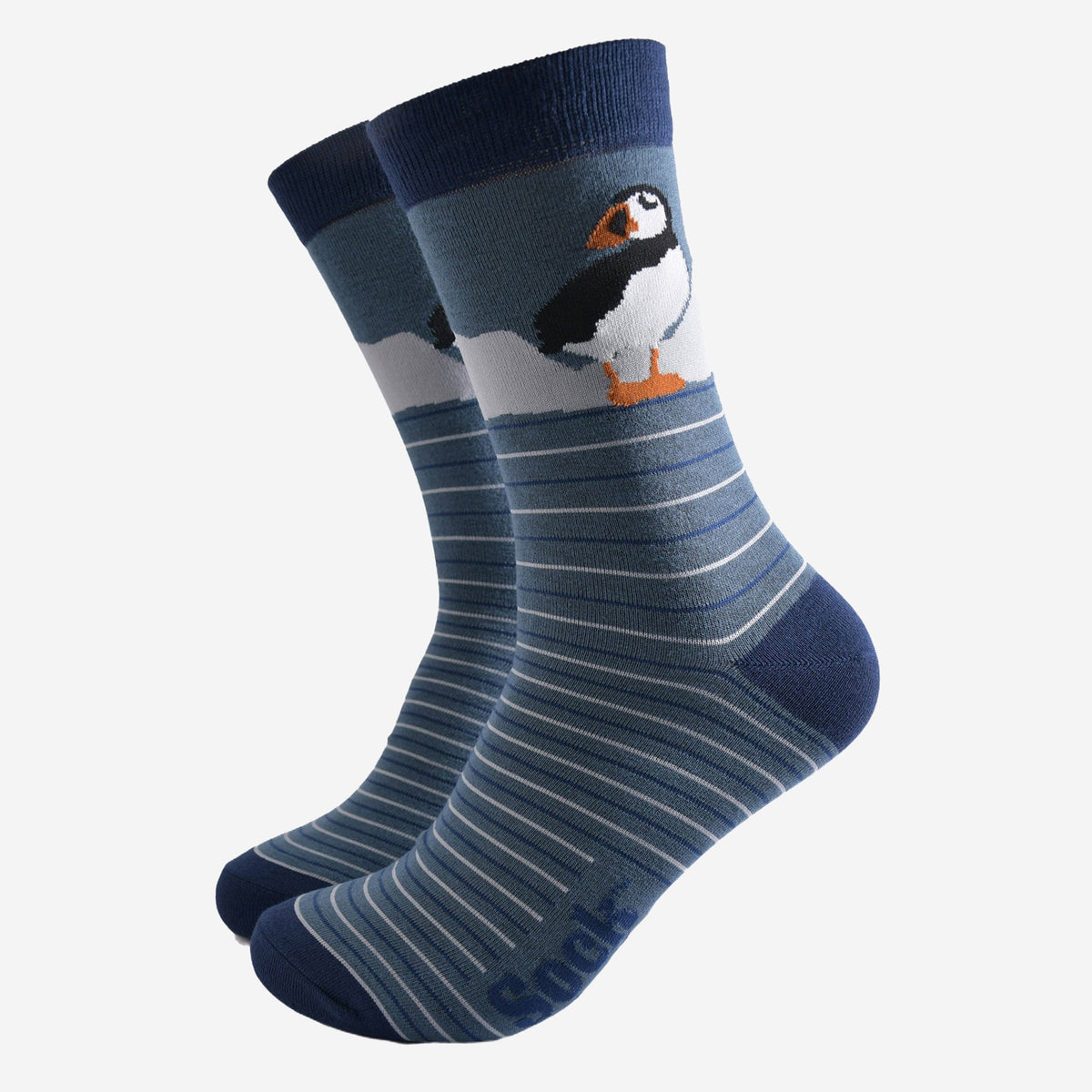 Pair of socks with a penguin design on a light gray background
