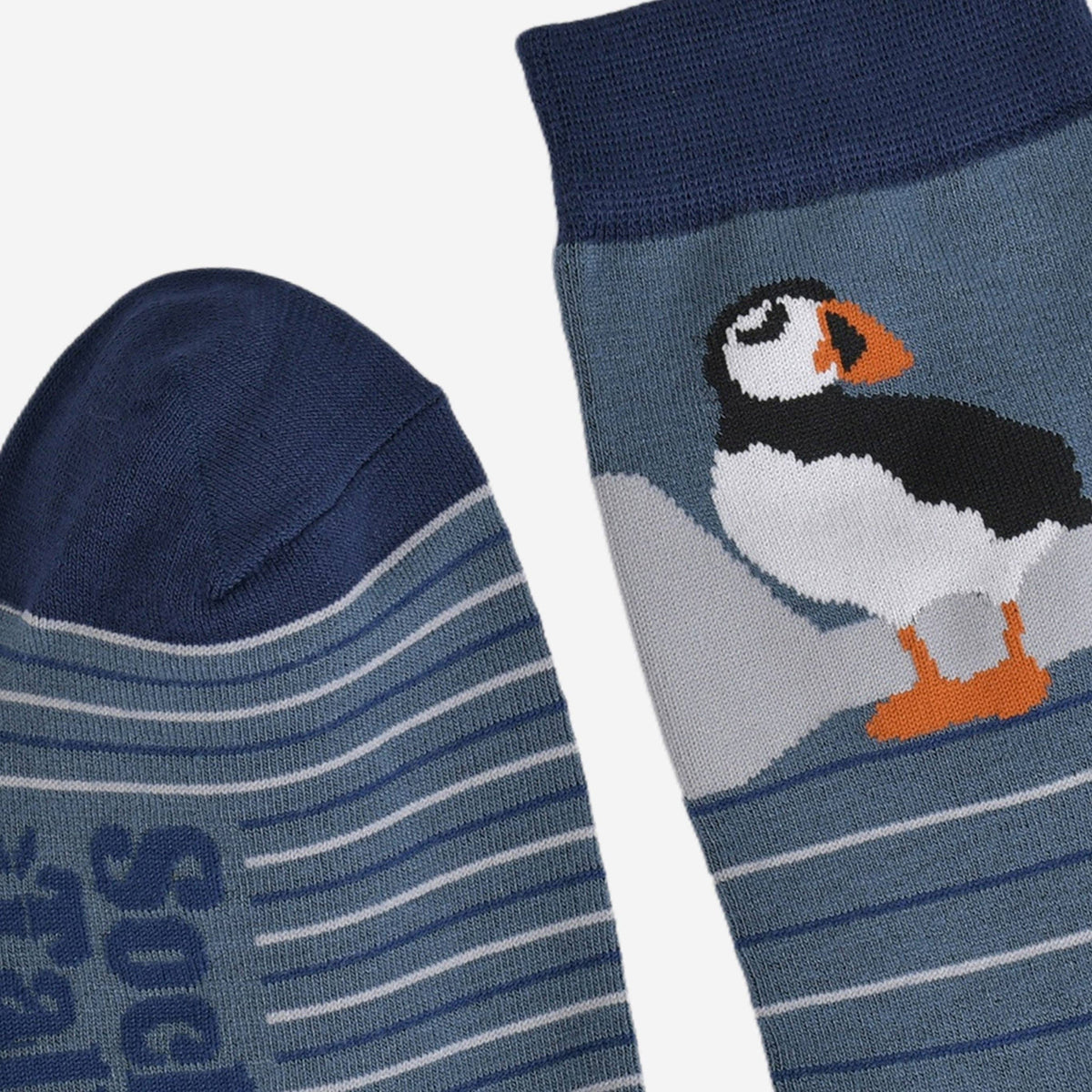 Navy blue sock with puffin design and striped pattern on a white background
