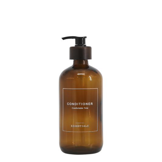 Brown conditioner bottle with pump on a white background