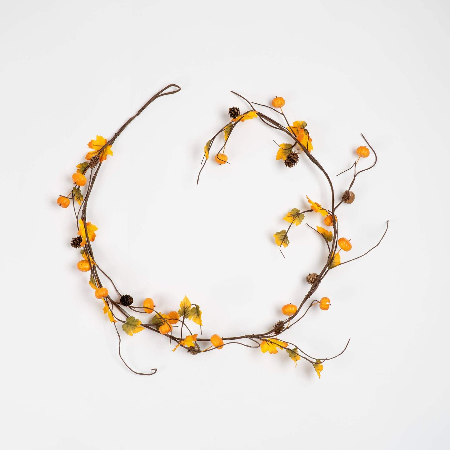 A rustic autumn floral garland with yellow-orange berries, small brown acorns, and dried leaves on a thin brown vine, arranged in a circle on a plain white background.