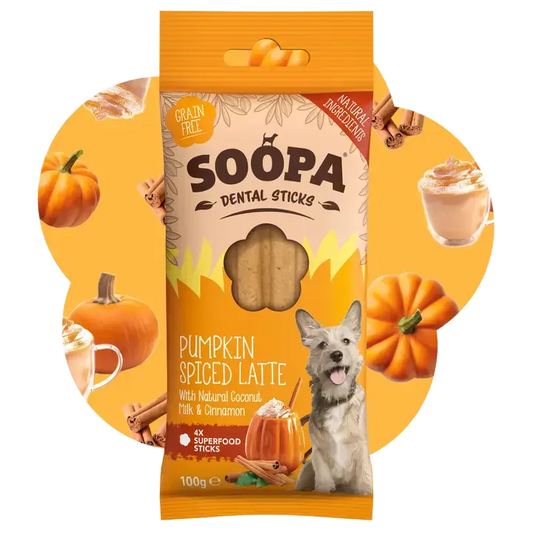 A package of Soopa Dental Sticks dog treats in the Pumpkin Spiced Latte flavor, shown against a circular orange background with pumpkins, cinnamon sticks, and a small dog illustration.
