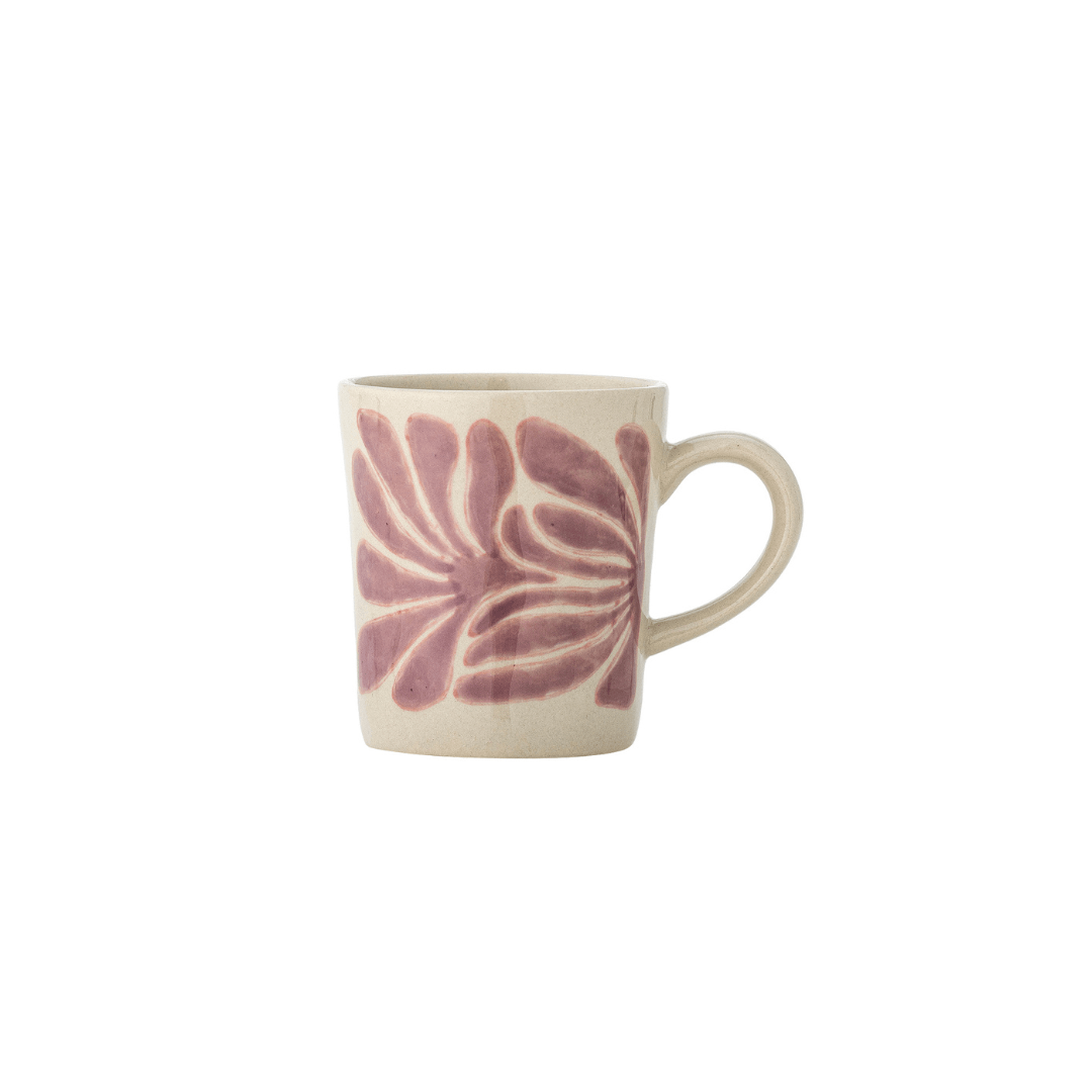 A small ceramic mug with a beige hand-painted floral pattern in dusty pink, set against a plain white background.