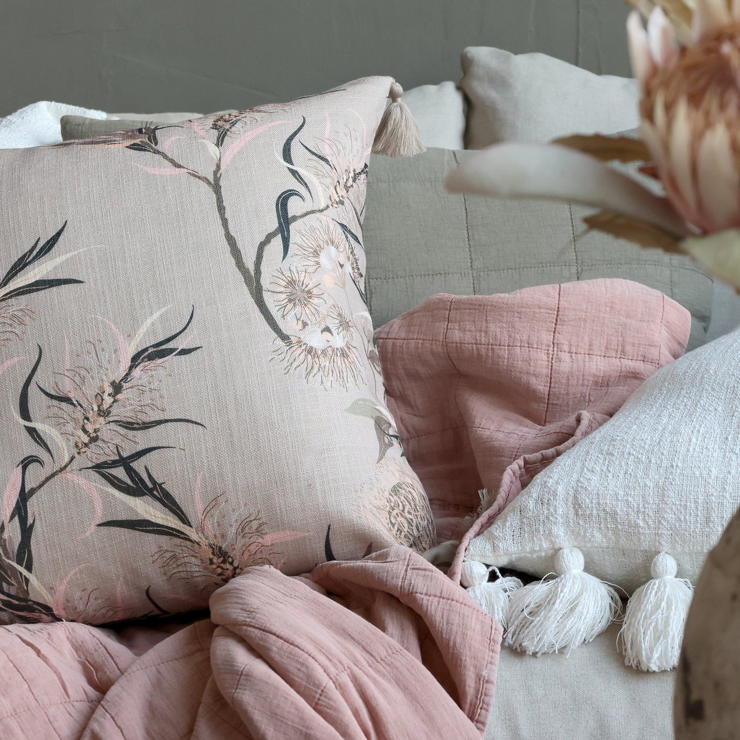 Dusky pink taupe quilt on a sofa