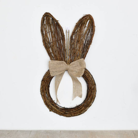 Wreath with bunny ears and a bow on a white background
