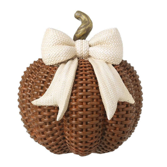 Decorative woven pumpkin with a white bow on a white background