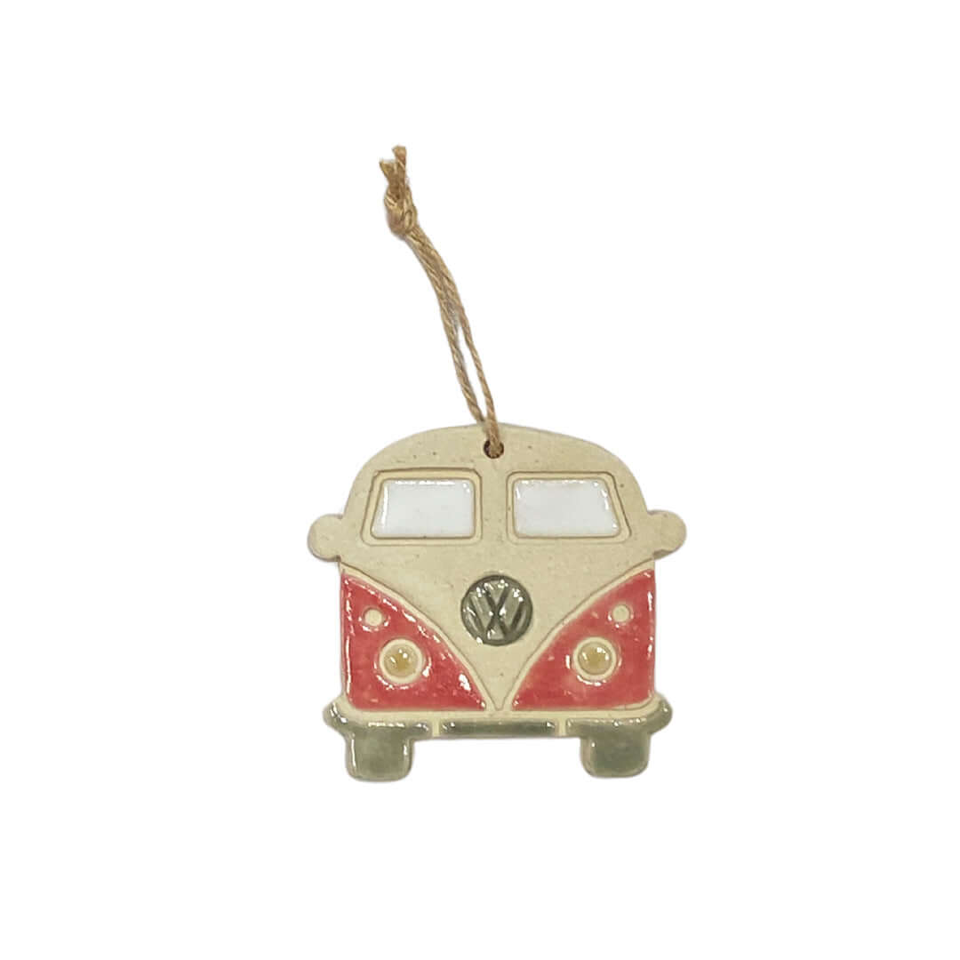 A ceramic decoration in the shape of a retro VW camper van, hanging from a string.