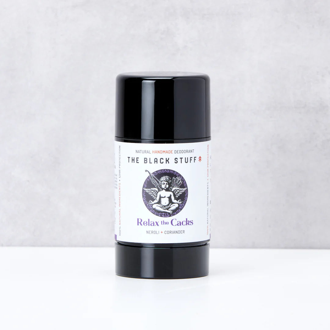 Deodorant stick with black cap and white label on a light gray background