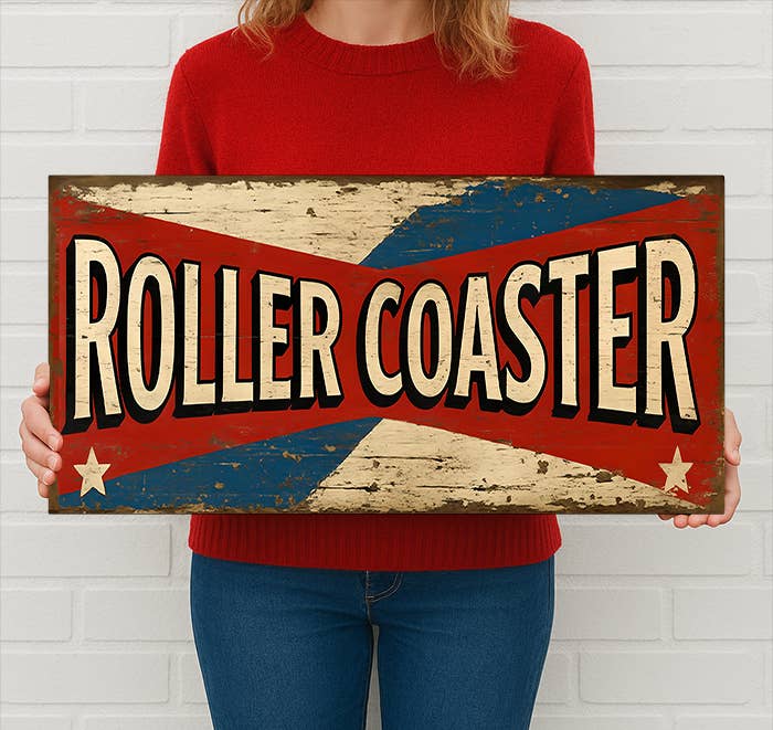 Person holding a 'Roller Coaster' sign with a red, white, and blue design.