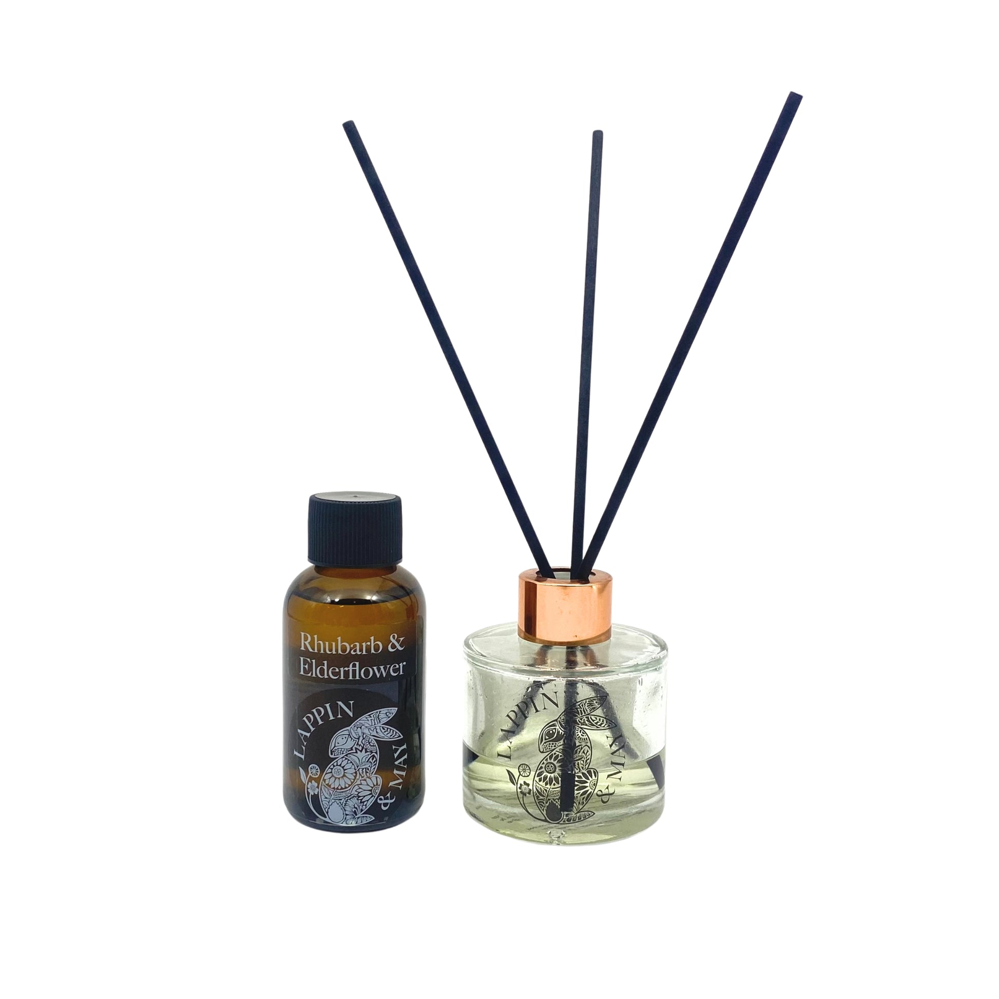 A bottle of Rhubarb & Elderflower fragrance oil with a copper cap, alongside a diffuser with a similar fragrance.