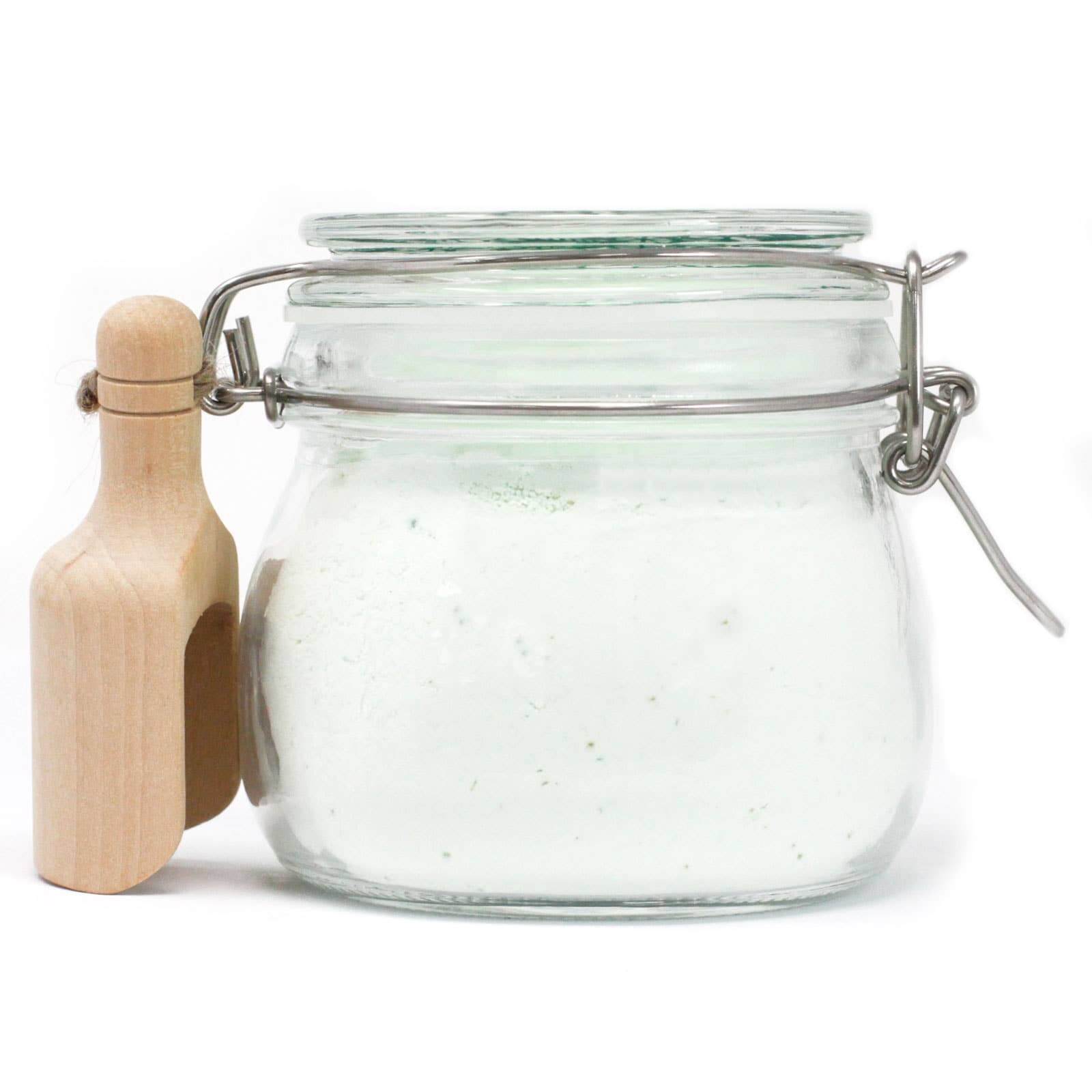 Rhubarb fairy dust in kilner jar with wooden scoop on a white background