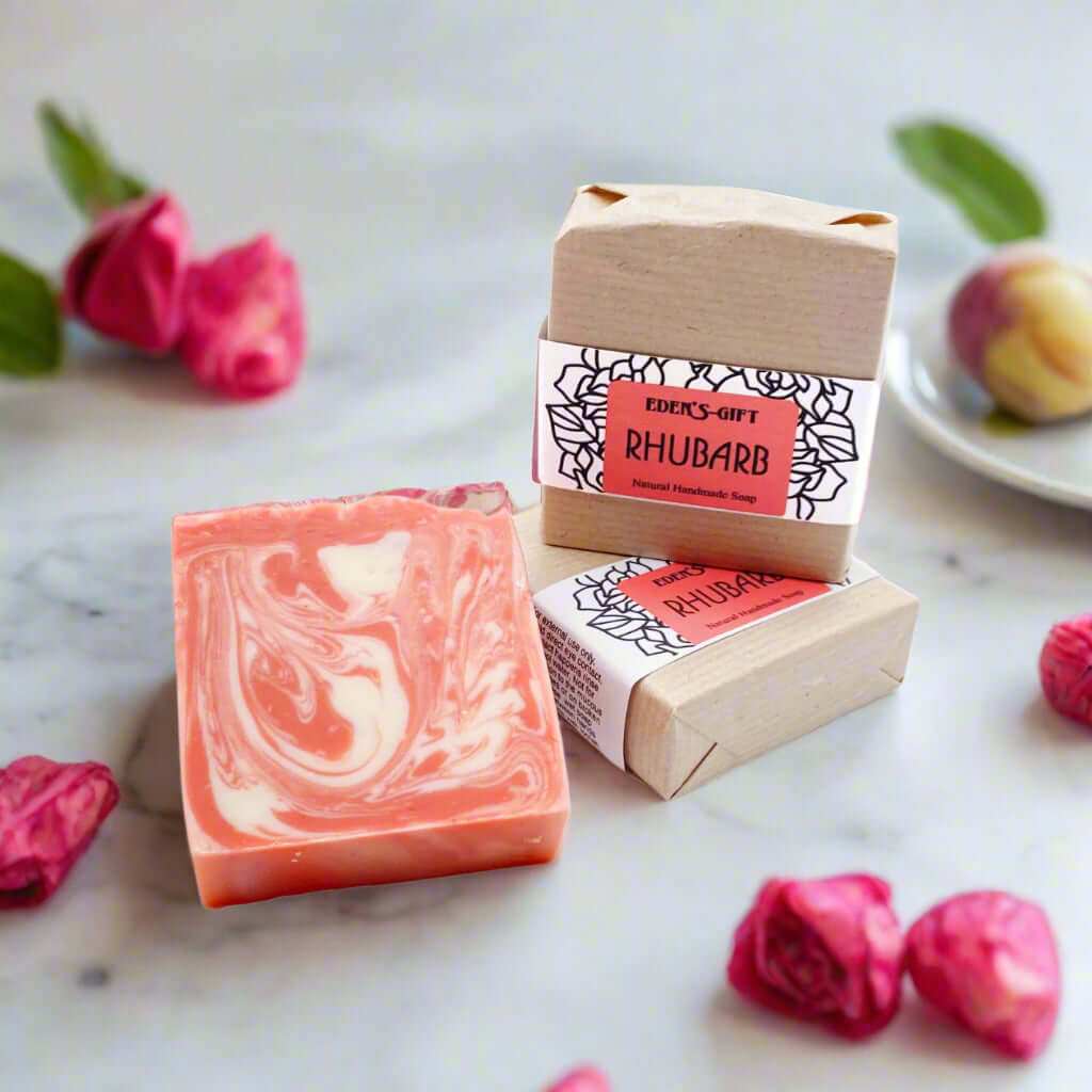 A packaged bar of handmade rhubarb soap with a label showing the brand and product name, set against a neutral background.
