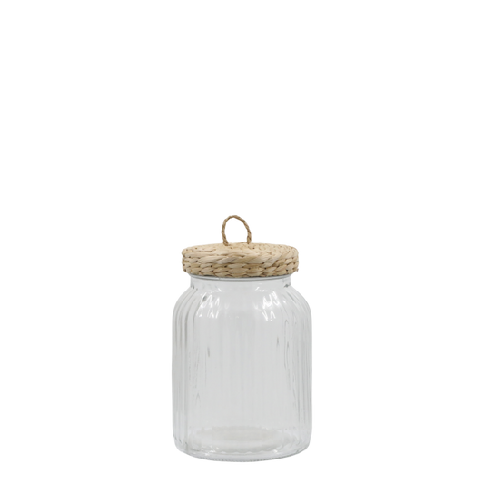 Ribbed glass storage jar with wicker lid on white background