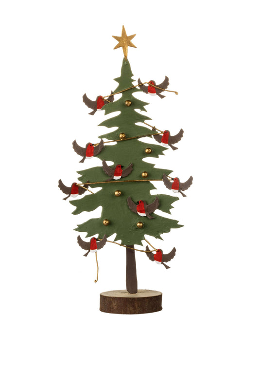 A decorative metal Christmas tree with a green pine-leaf silhouette, brown trunk, gold star topper, small gold ornaments, and multiple red-and-white robin birds perched along the branches, displayed on a round wood slice base against a white background.
