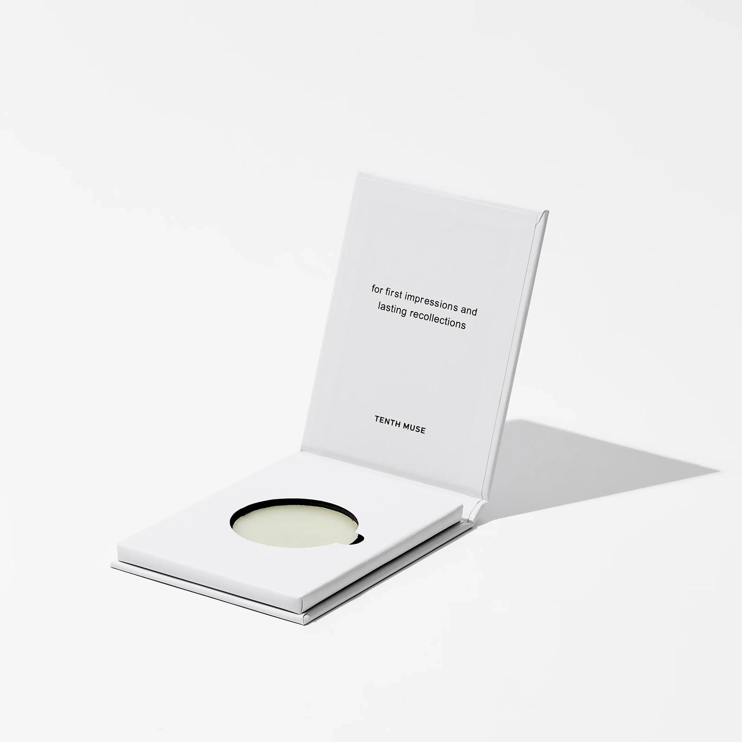 Salted Skin solid perfume balm with a white card on a light gray background