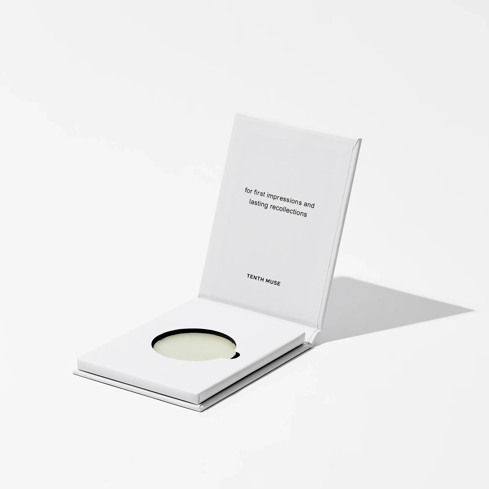 Salted Skin solid perfume balm with a white card on a light gray background
