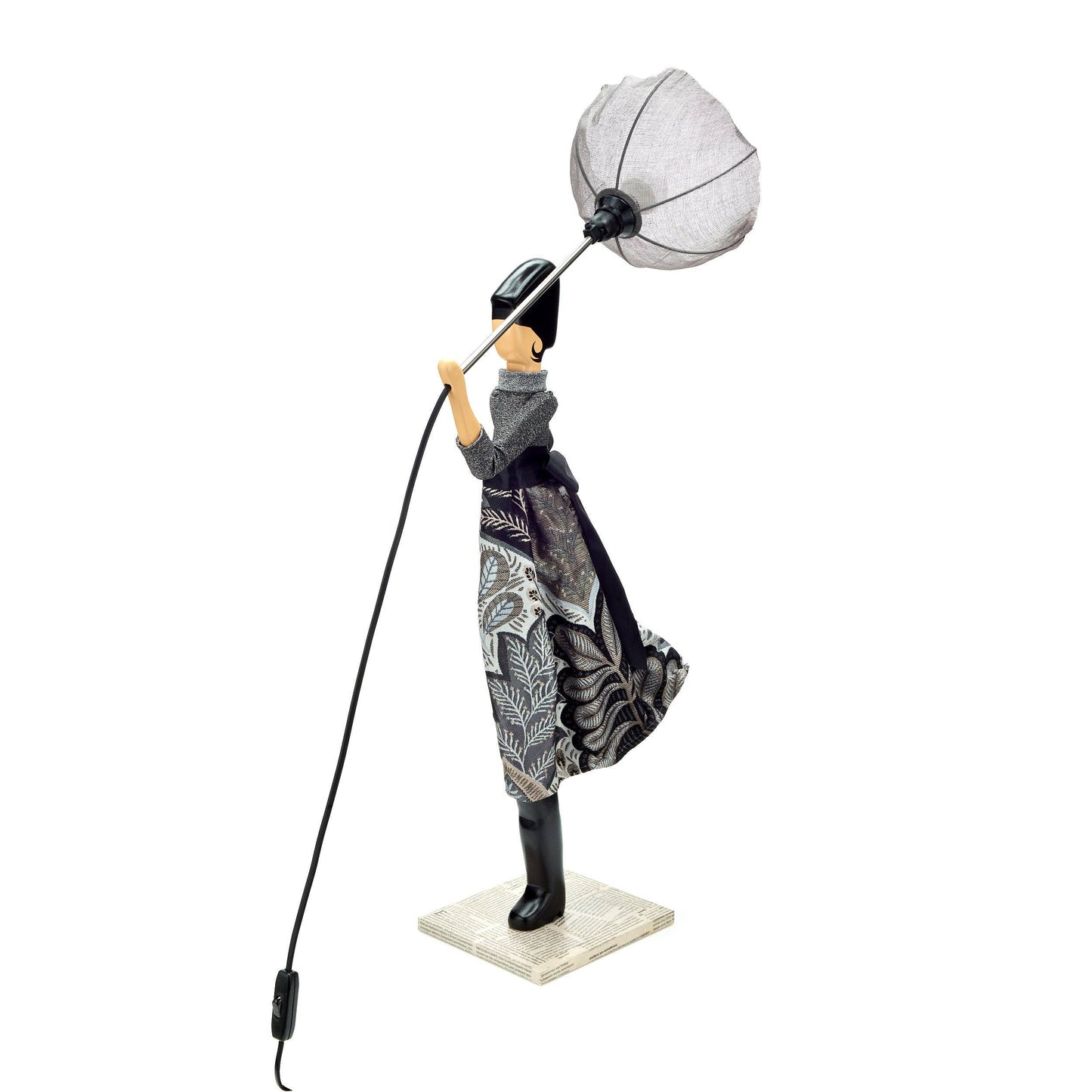 Decorative figure of a person holding a lamp with a white shade on a white background