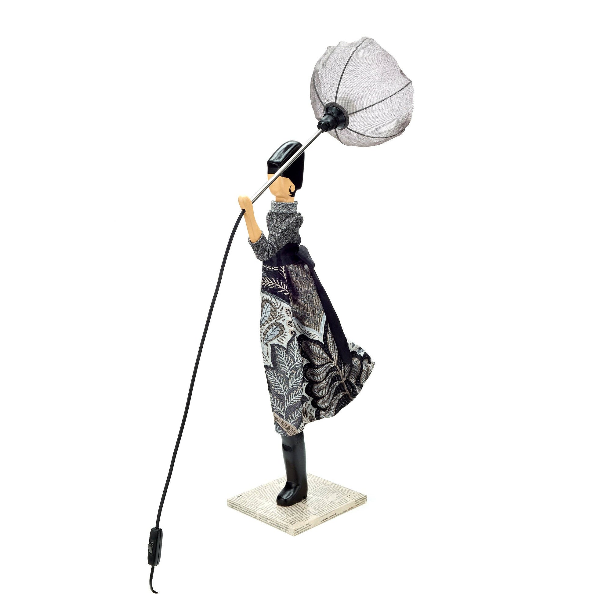 Decorative figure of a person holding a lamp with a white shade on a white background