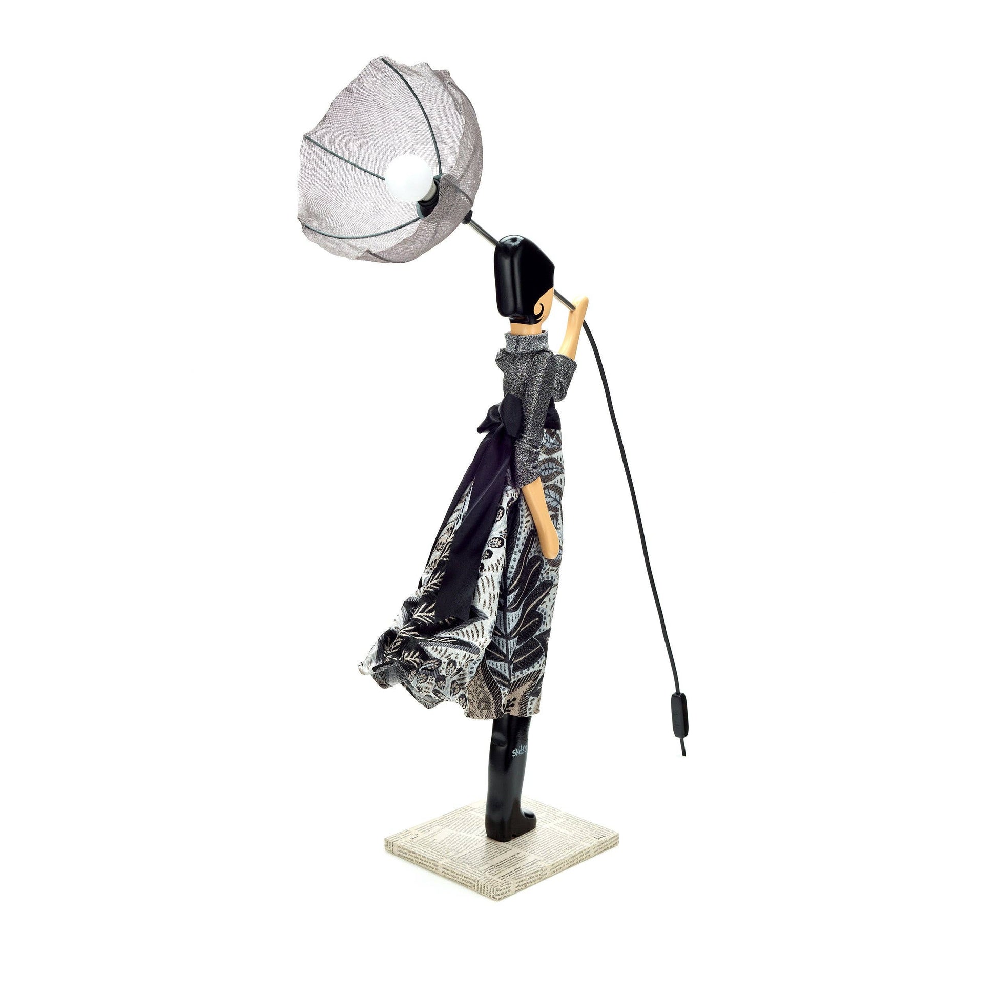 Decorative figure with umbrella and lamp on a white background