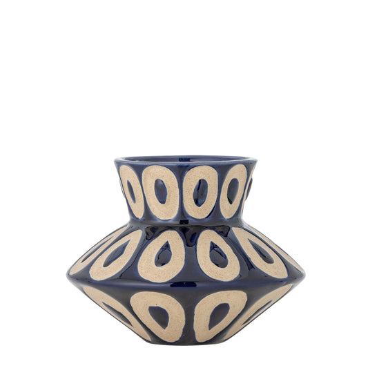 Blue ceramic vase with beige circular patterns on a white background