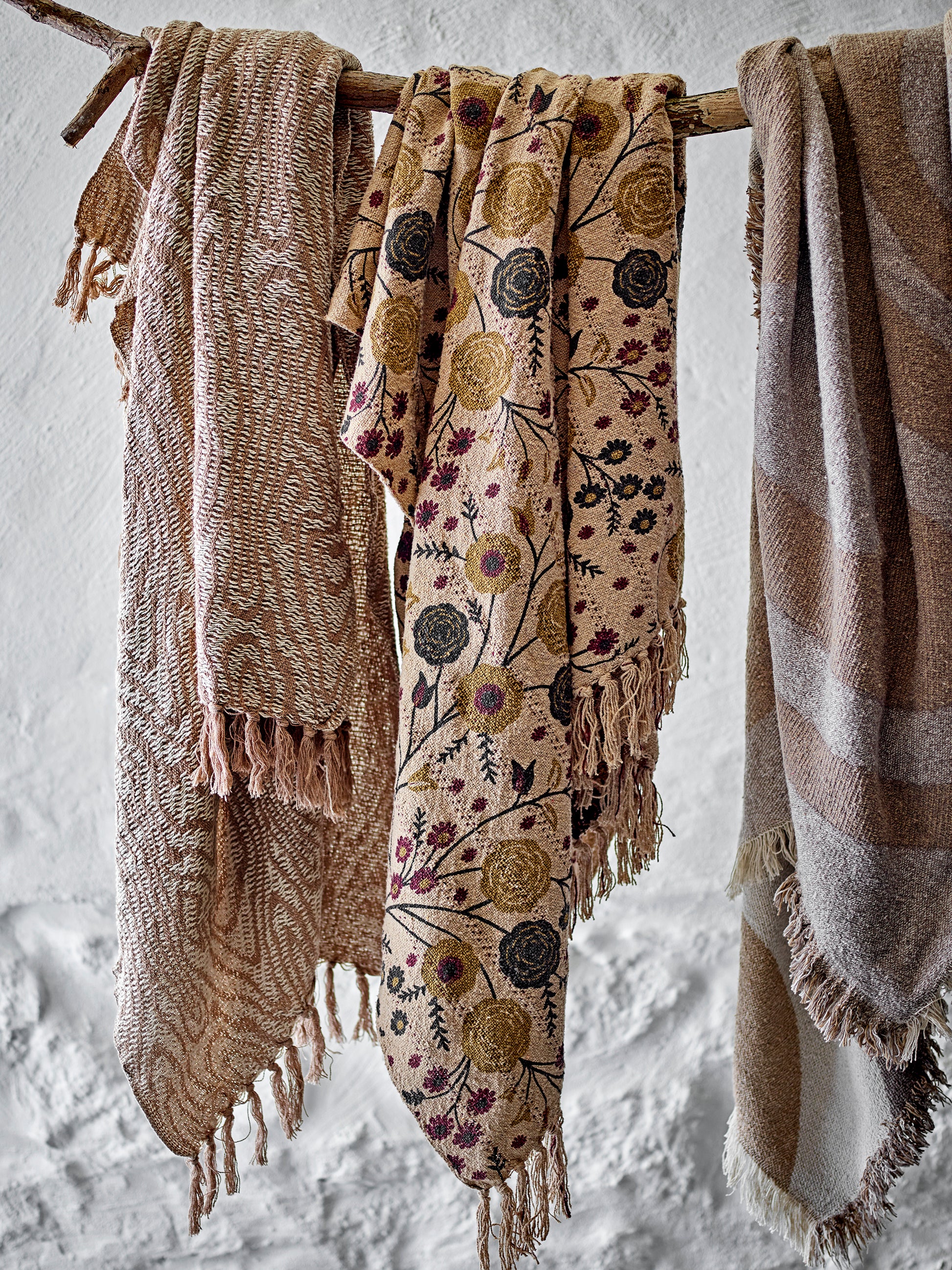 Bloomingville Eydis Recycled Cotton Throw hanging over a stick