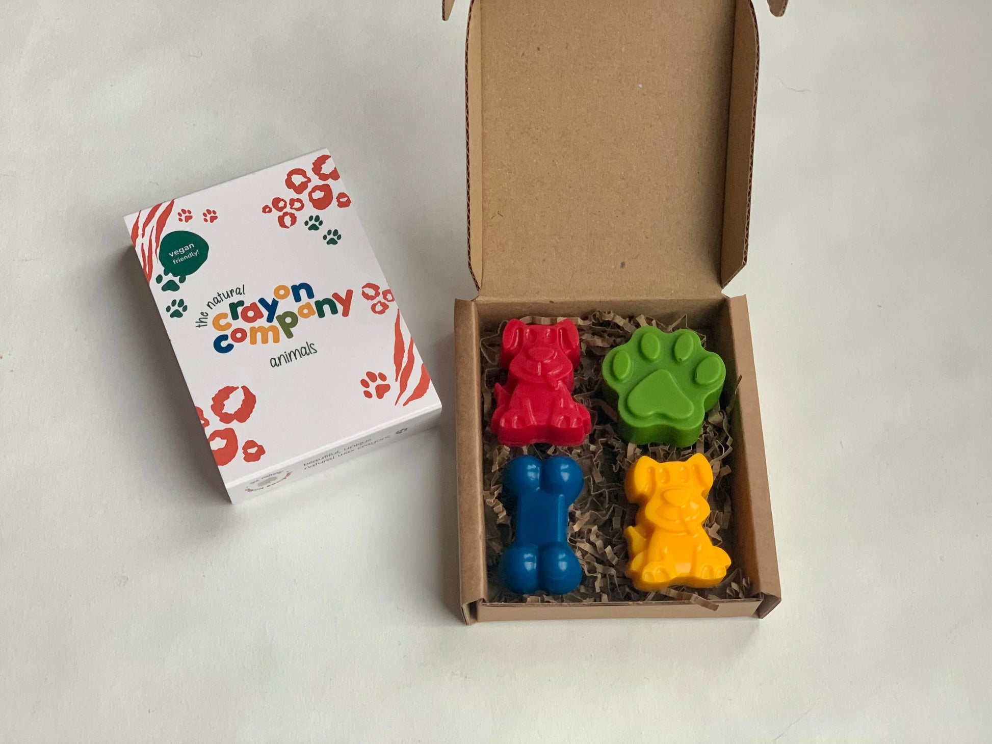 Colorful dog crayon set with packaging on a white background
