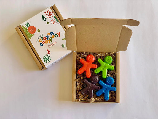 Colorful gingerbread men in a box with a branded box on a white background