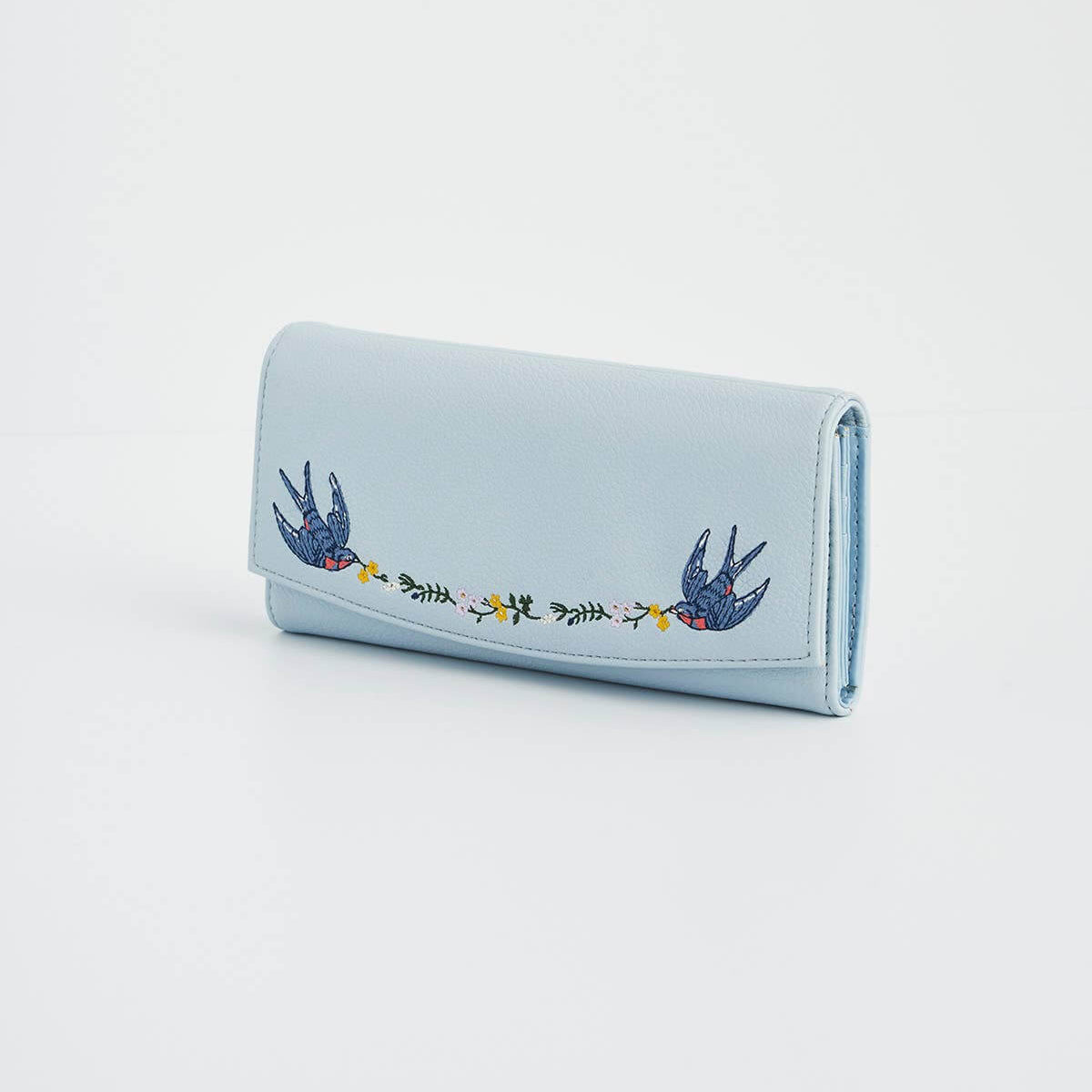 Light blue wallet with embroidered design on a white background