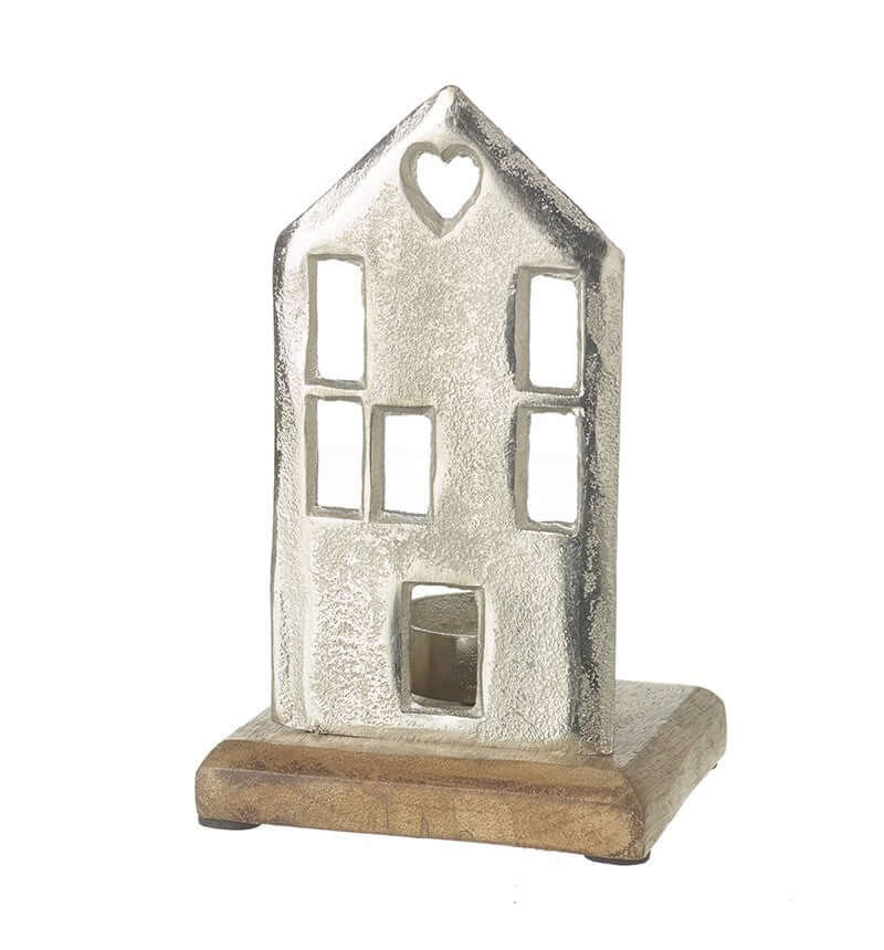 Decorative house-shaped candle holder with a heart window on a white background