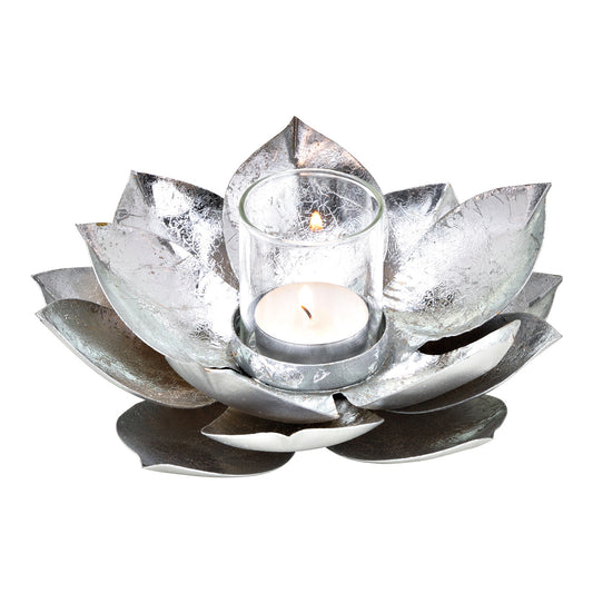 Silver lotus-shaped candle holder with a lit candle on a white background