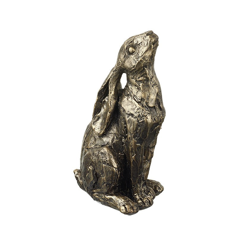 Resin sculpture of a sitting hare on a white background.