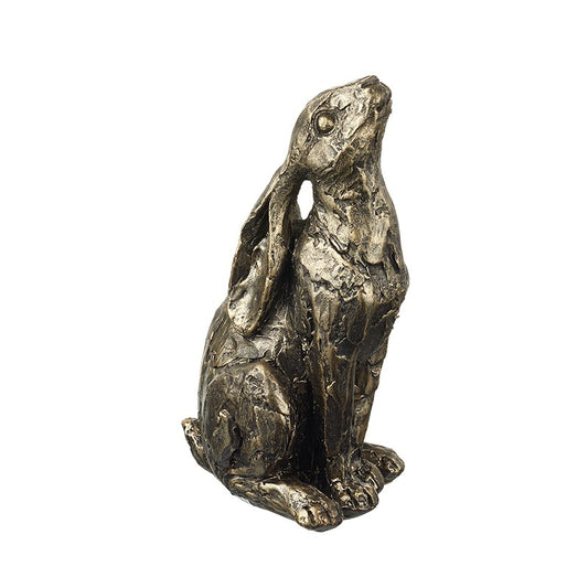 Resin sculpture of a sitting hare on a white background.