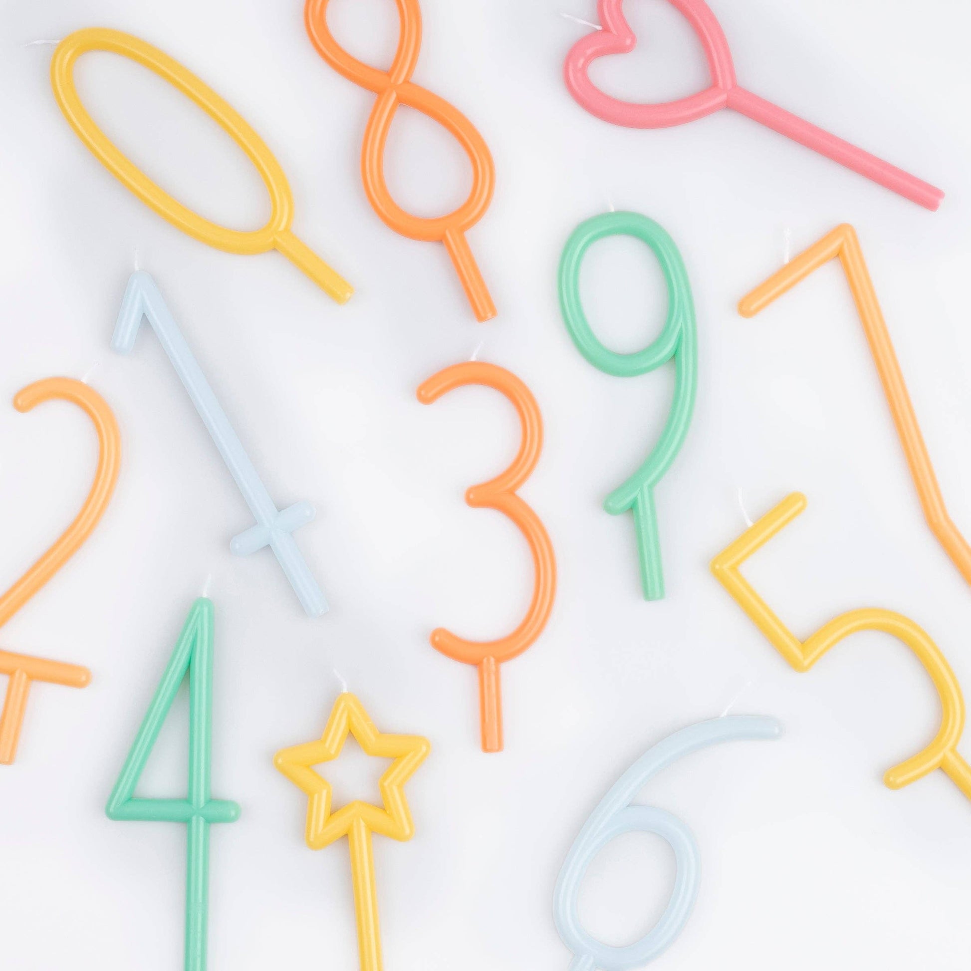 Colorful number-shaped straws on a white background