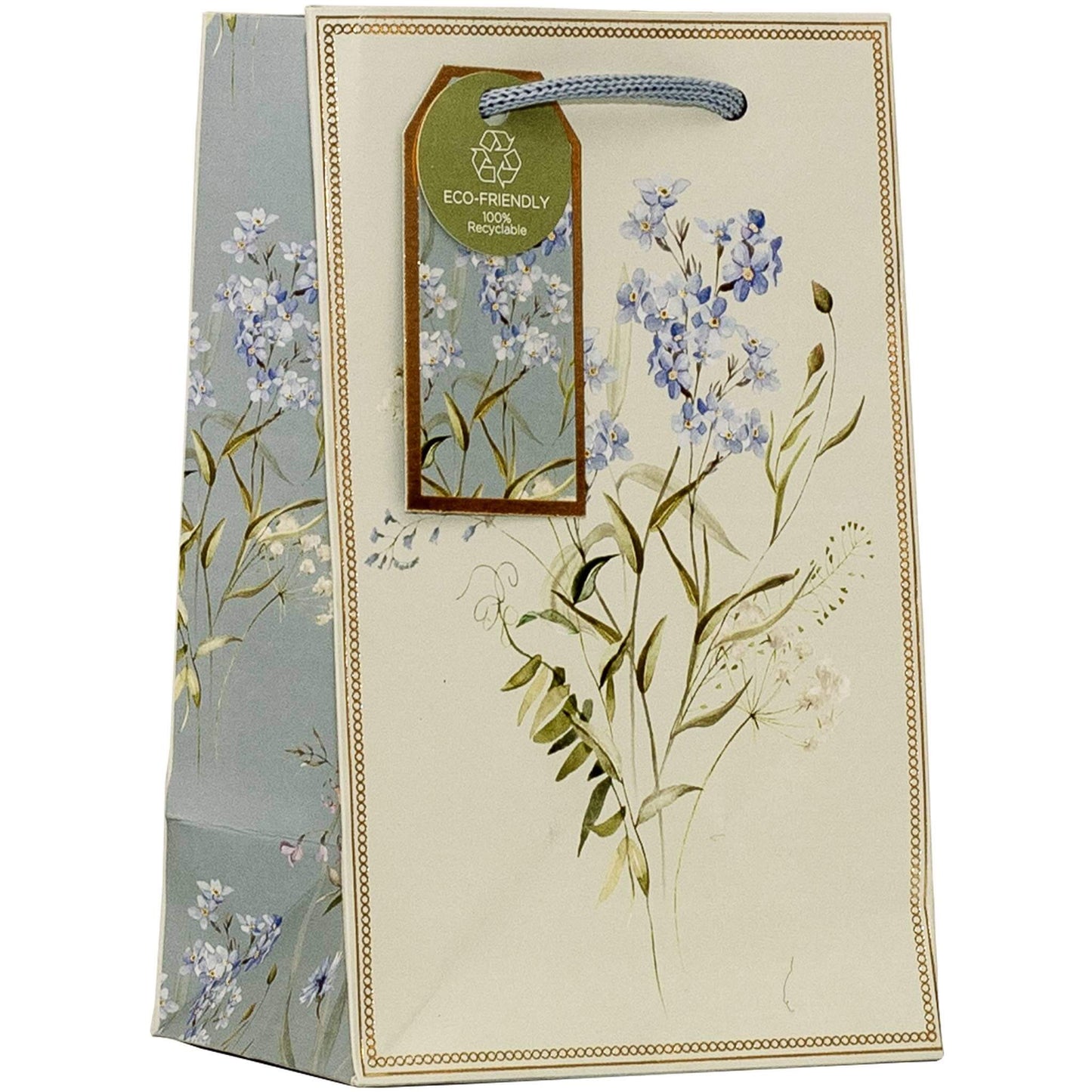 A decorative gift bag with a cream-colored front panel, blue and white floral illustrations, a blue rope handle, and a hanging green 'Eco-Friendly' tag.