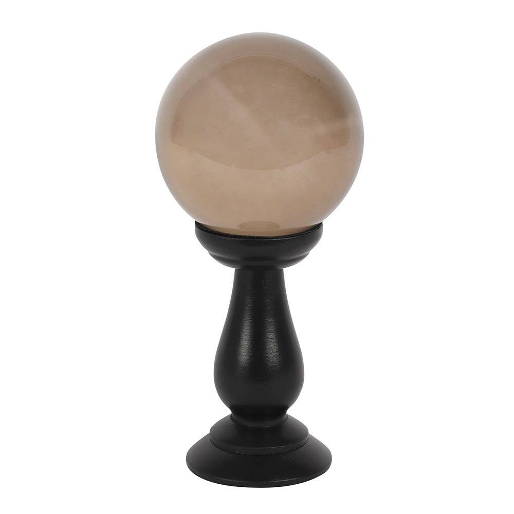 Decorative sphere on a black stand against a white background