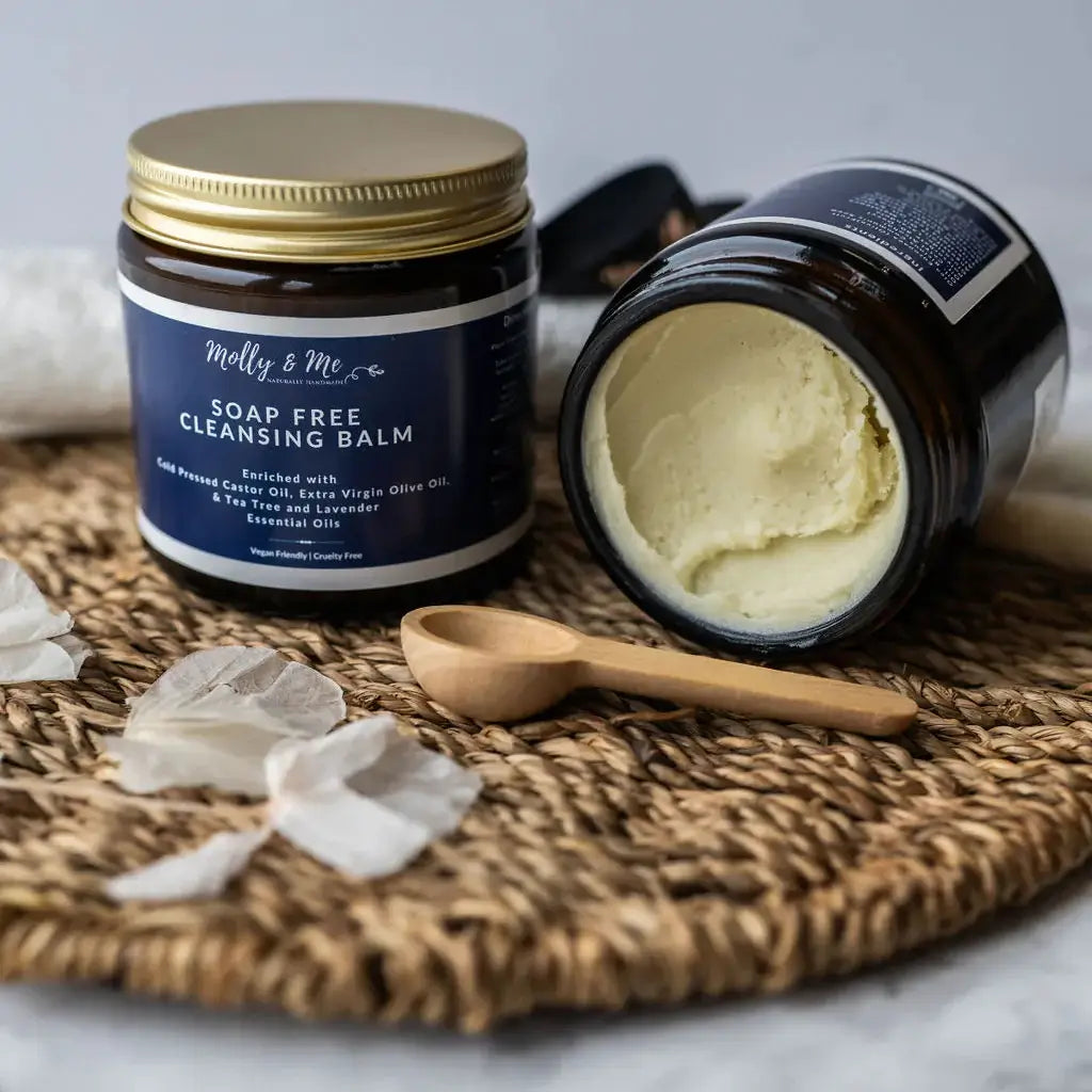 Soap free cleansing balm jar with a wooden spoon on a woven mat